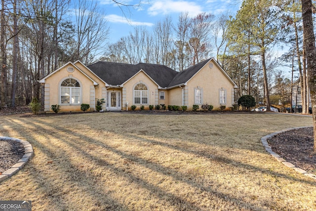 view of front of house featuring a front lawn and stucco siding