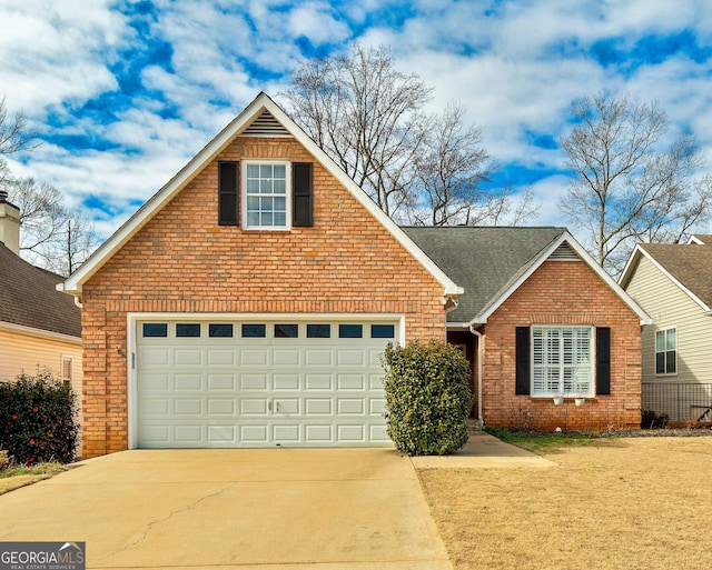 traditional home with a garage, concrete driveway, brick siding, and roof with shingles