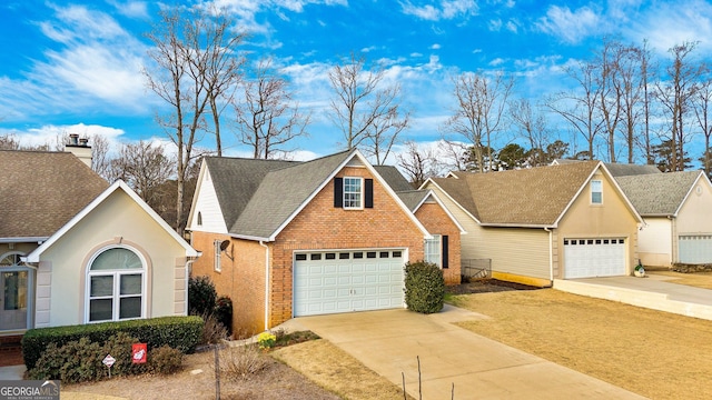 traditional-style house featuring a garage, brick siding, and a shingled roof