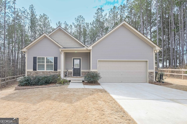 craftsman-style home featuring a garage, stone siding, and concrete driveway