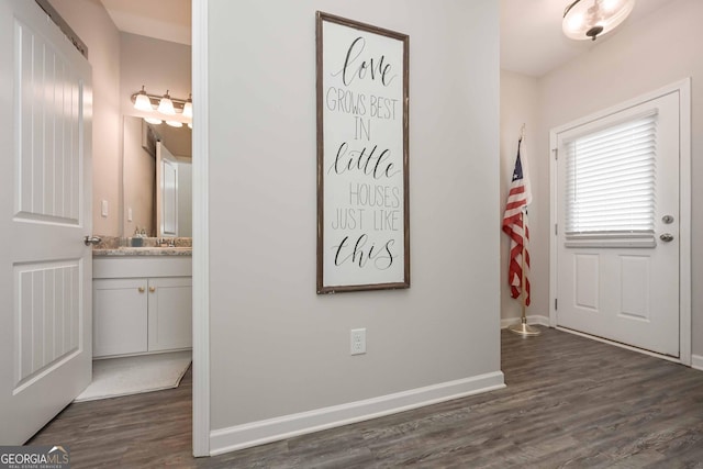 entrance foyer featuring dark wood-style flooring and baseboards