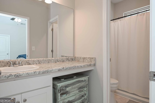 bathroom featuring toilet, tile patterned floors, a shower with shower curtain, and vanity