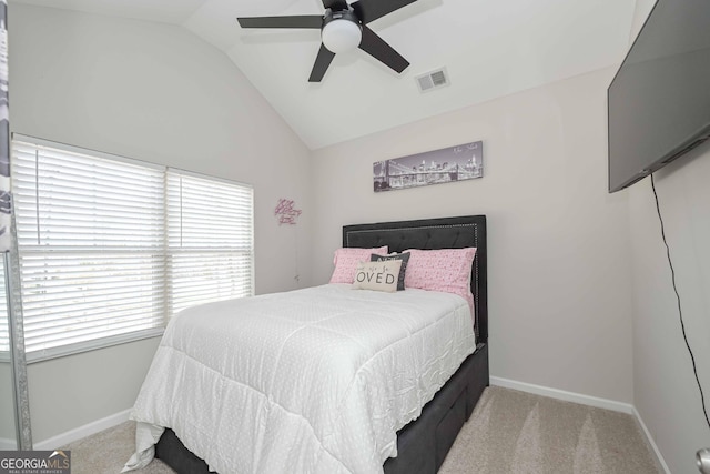 carpeted bedroom featuring lofted ceiling, a ceiling fan, visible vents, and baseboards