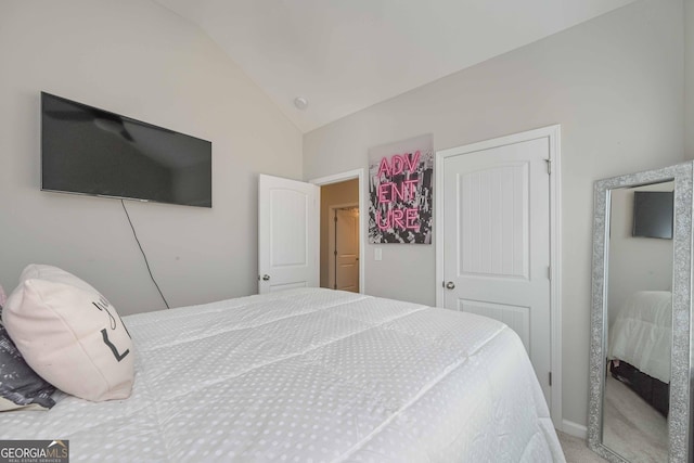 bedroom with lofted ceiling and carpet