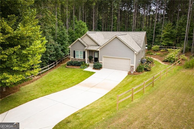 view of front facade with a garage, concrete driveway, stone siding, fence, and a front yard