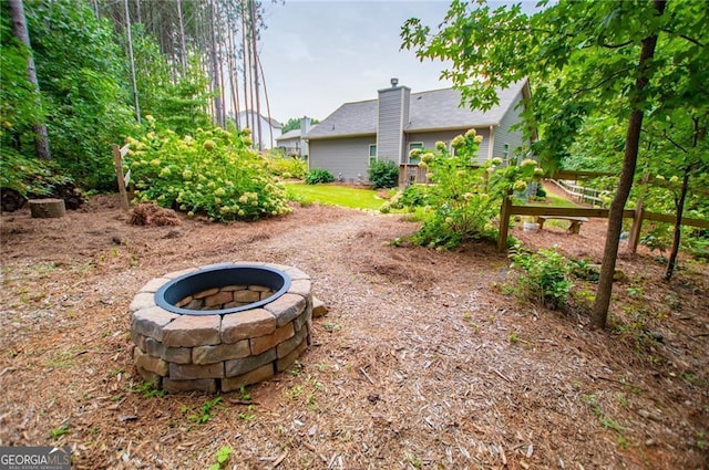 view of yard with a fire pit