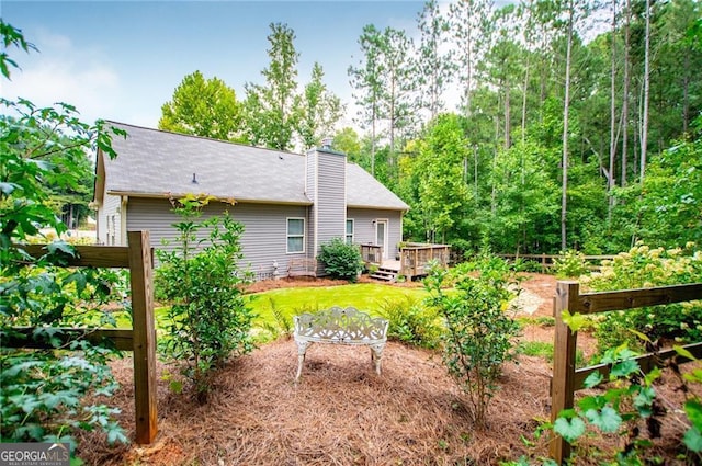 view of yard with a deck and a garden