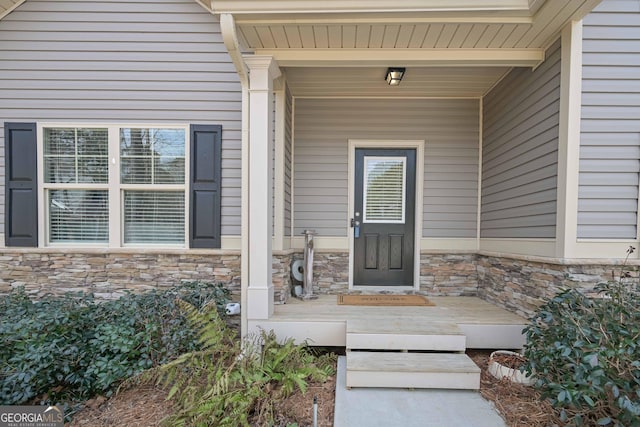 doorway to property featuring stone siding