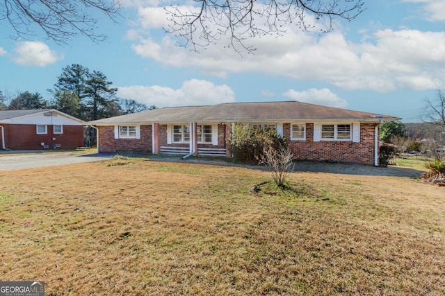 ranch-style house with brick siding and a front lawn