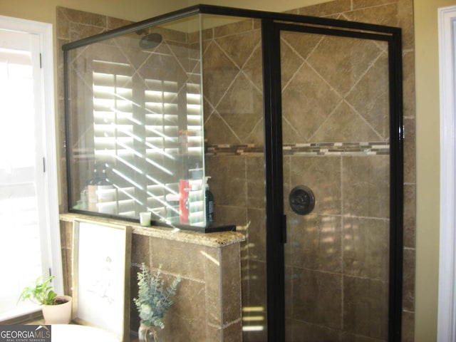 full bath featuring a shower stall