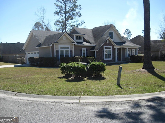 craftsman house featuring an attached garage and a front yard