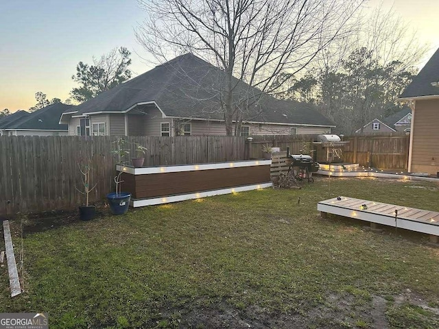 exterior space featuring a lawn and a fenced backyard