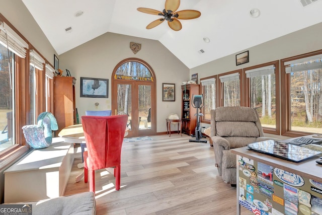 interior space featuring high vaulted ceiling, french doors, light wood-style flooring, and a healthy amount of sunlight