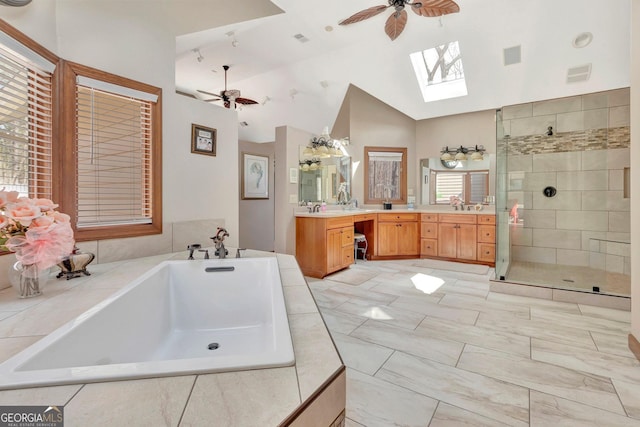 bathroom with visible vents, a stall shower, a ceiling fan, a bath, and lofted ceiling with skylight