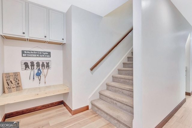 mudroom featuring light wood-style flooring and baseboards