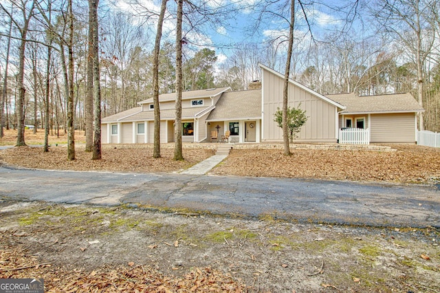 mid-century inspired home with a porch and board and batten siding