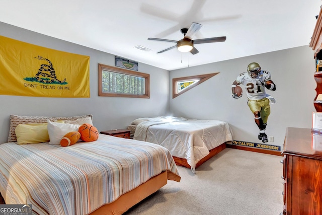 carpeted bedroom with visible vents and a ceiling fan