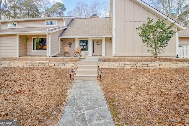 view of front of property with a chimney and roof with shingles