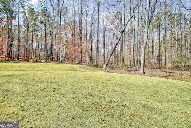 view of yard with a forest view