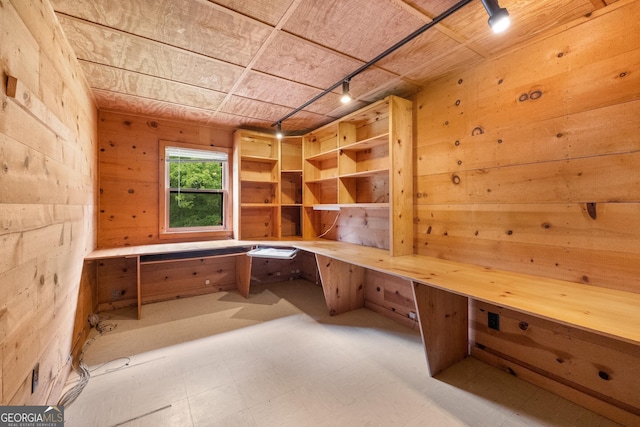 unfurnished office featuring a sauna, built in desk, and tile patterned floors