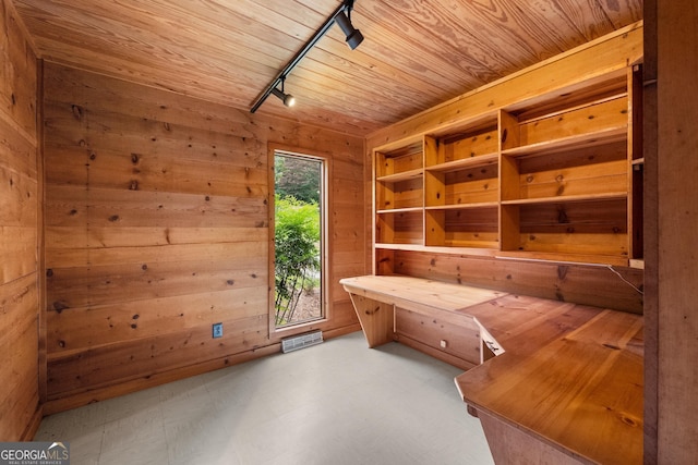 unfurnished office with a sauna, wood walls, wooden ceiling, and rail lighting