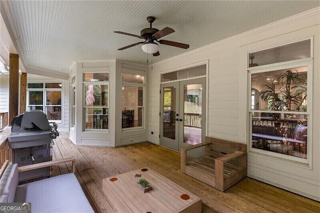 sunroom with plenty of natural light, french doors, and ceiling fan