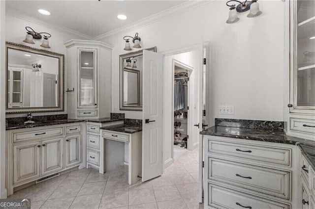 bathroom featuring visible vents, crown molding, vanity, and tile patterned floors