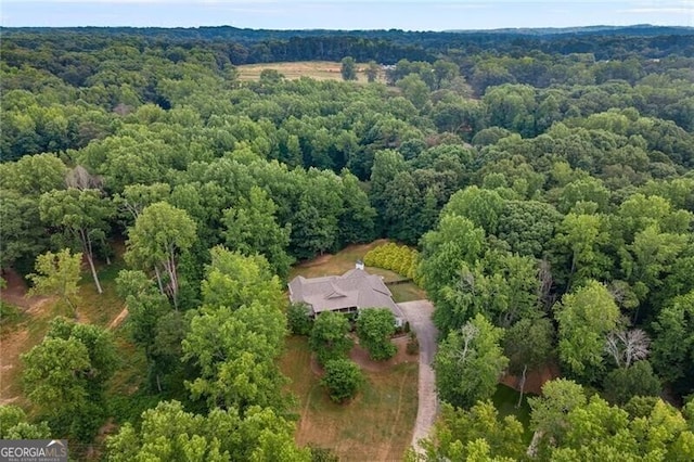 drone / aerial view with a wooded view