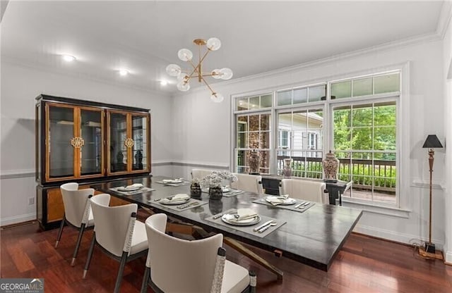 dining area with a chandelier, dark wood finished floors, crown molding, and baseboards