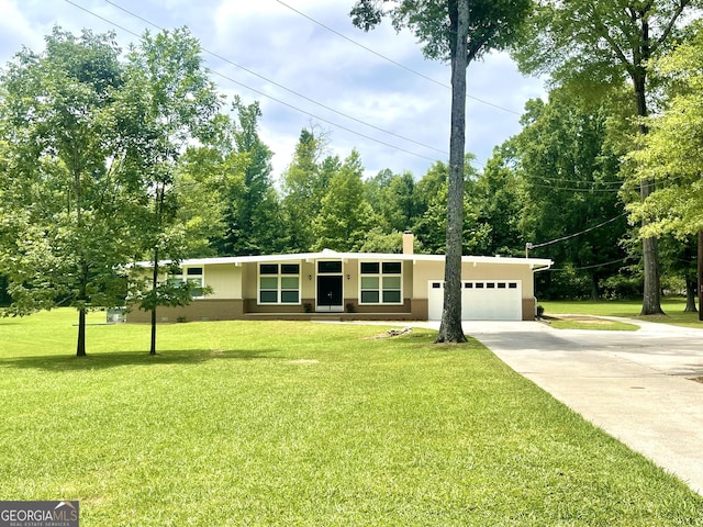 view of front of house with a chimney, stucco siding, concrete driveway, an attached garage, and a front lawn