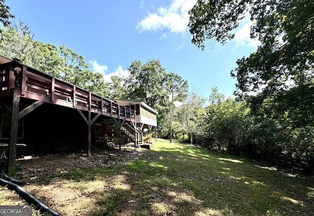 view of yard featuring stairway and a deck