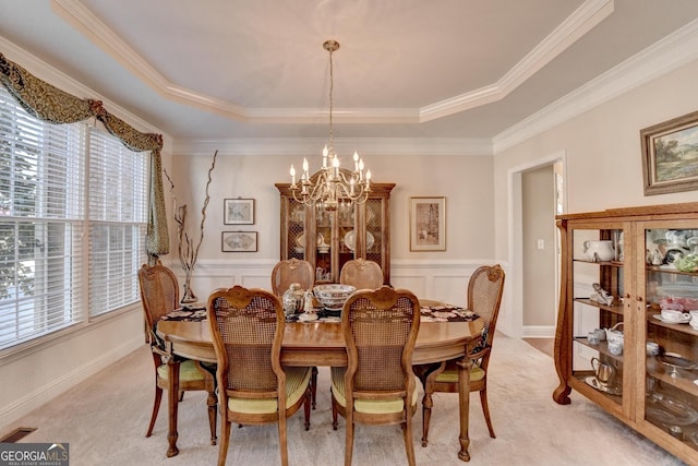 1301 Dayspring Trce, Lawrenceville, GA 30045 - dining room with light carpet, visible vents, a raised ceiling, wainscoting, and a notable chandelier