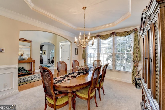 1301 Dayspring Trce, Lawrenceville, GA 30045 - dining room featuring light carpet, crown molding, a raised ceiling, and a notable chandelier