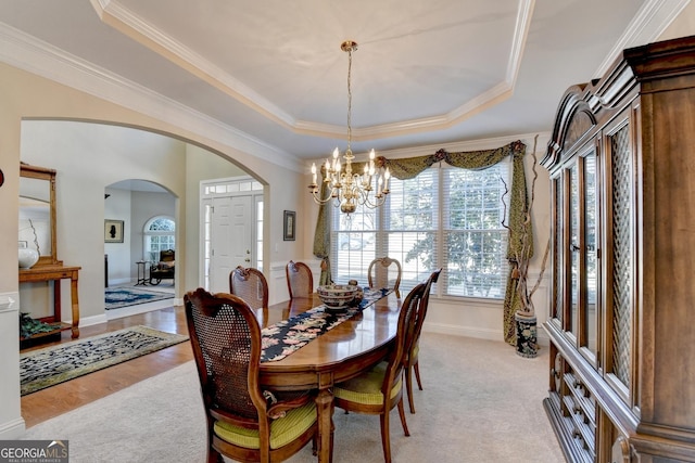 1301 Dayspring Trce, Lawrenceville, GA 30045 - dining space featuring ornamental molding, a raised ceiling, and an inviting chandelier