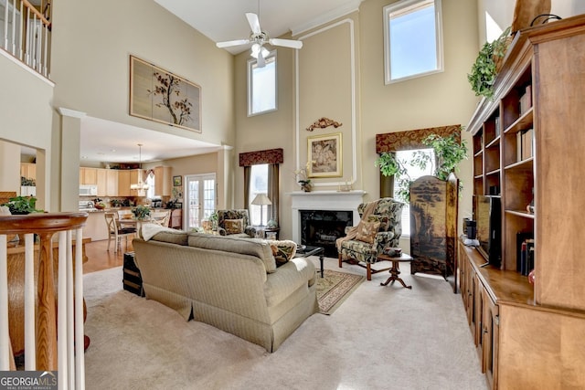 1301 Dayspring Trce, Lawrenceville, GA 30045 - living area with light carpet, ceiling fan, a premium fireplace, and a towering ceiling