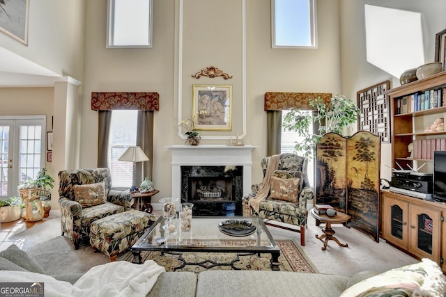 1301 Dayspring Trce, Lawrenceville, GA 30045 - carpeted living area with a premium fireplace, a high ceiling, a wealth of natural light, and french doors