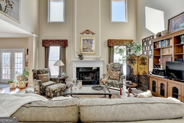 1301 Dayspring Trce, Lawrenceville, GA 30045 - living room featuring a high end fireplace, plenty of natural light, and a high ceiling