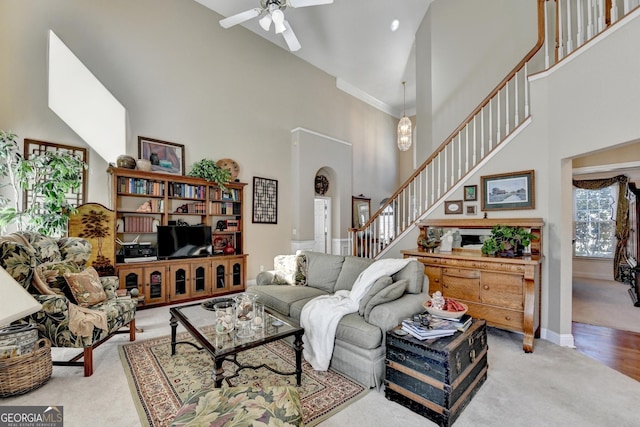 1301 Dayspring Trce, Lawrenceville, GA 30045 - carpeted living area with a towering ceiling, ceiling fan, stairs, and baseboards