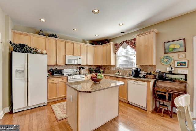 1301 Dayspring Trce, Lawrenceville, GA 30045 - kitchen with light wood-type flooring, white appliances, light brown cabinets, and a sink