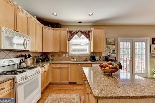 1301 Dayspring Trce, Lawrenceville, GA 30045 - kitchen with light brown cabinets, french doors, white appliances, and a sink