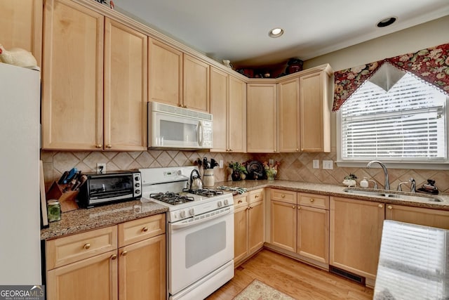 1301 Dayspring Trce, Lawrenceville, GA 30045 - kitchen with white appliances, light brown cabinets, a sink, and a toaster