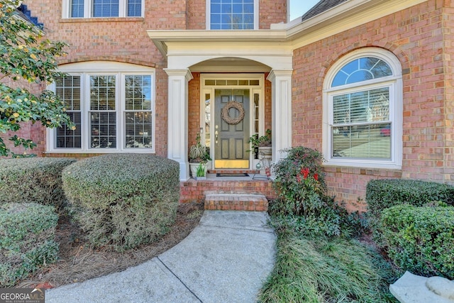 entrance to property featuring brick siding