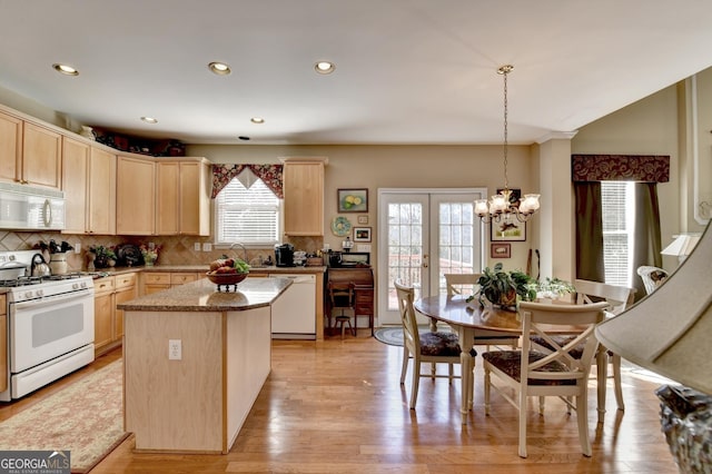 1301 Dayspring Trce, Lawrenceville, GA 30045 - kitchen featuring light brown cabinetry, white appliances, a kitchen island, and french doors