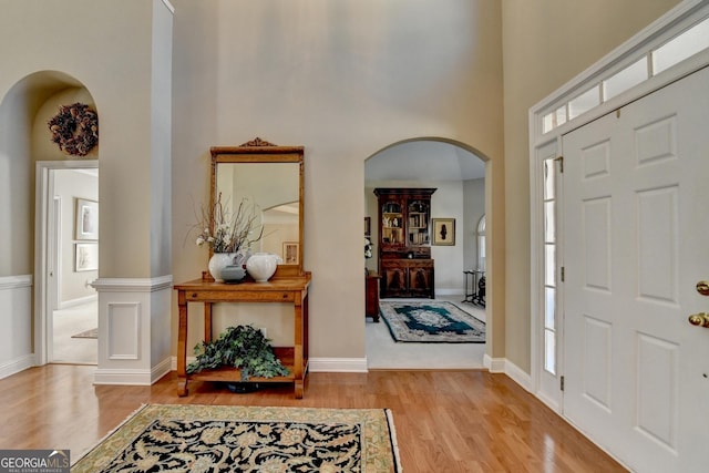 1301 Dayspring Trce, Lawrenceville, GA 30045 - foyer with arched walkways, wood finished floors, a towering ceiling, and baseboards