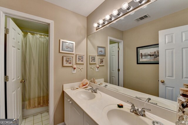 1301 Dayspring Trce, Lawrenceville, GA 30045 - bathroom with double vanity, visible vents, a sink, and tile patterned floors