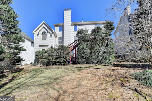 1301 Dayspring Trce, Lawrenceville, GA 30045 - back of house featuring stairway, a lawn, and a chimney