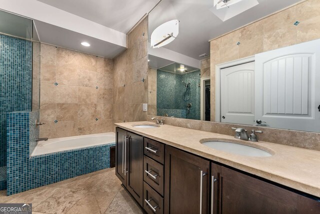 full bathroom featuring a sink, tile walls, tiled shower, and a relaxing tiled tub