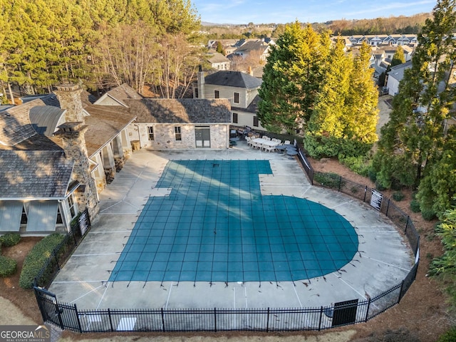 view of swimming pool with fence, a fenced in pool, a patio area, and a residential view
