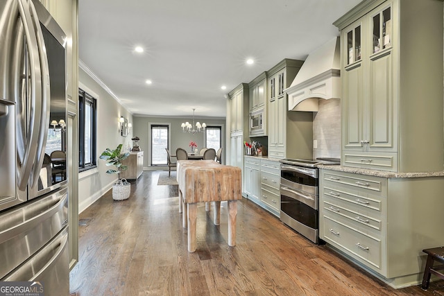 kitchen featuring dark wood-style flooring, ornamental molding, appliances with stainless steel finishes, custom exhaust hood, and tasteful backsplash