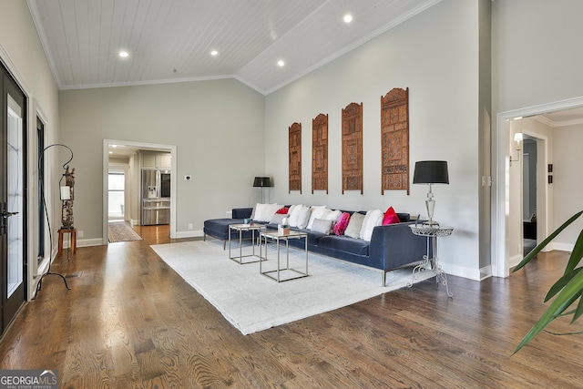 living room featuring ornamental molding, high vaulted ceiling, baseboards, and wood finished floors